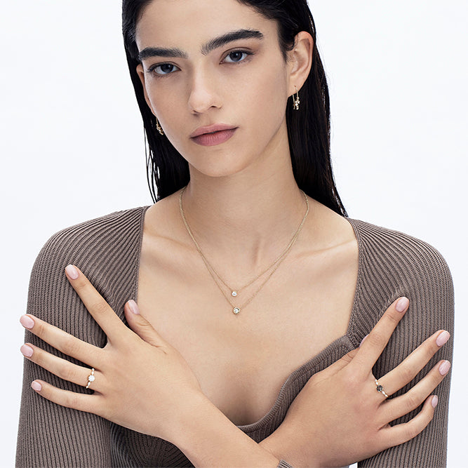 Engagement ring set with a 0.60 carat center round lab-grown diamond and marquise lab-grown diamonds