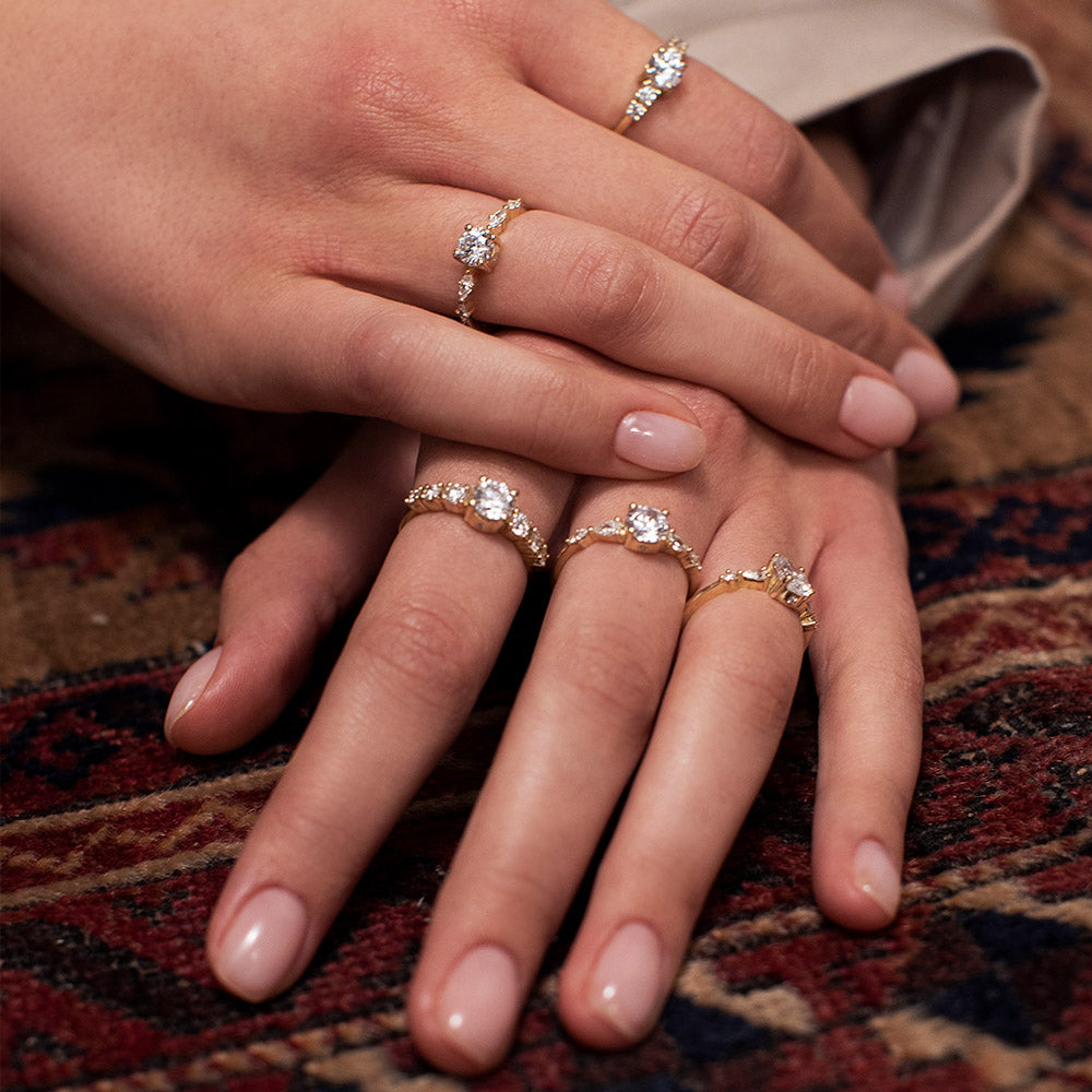 Engagement ring set with a 0.60 carat center round lab-grown diamond and marquise lab-grown diamonds
