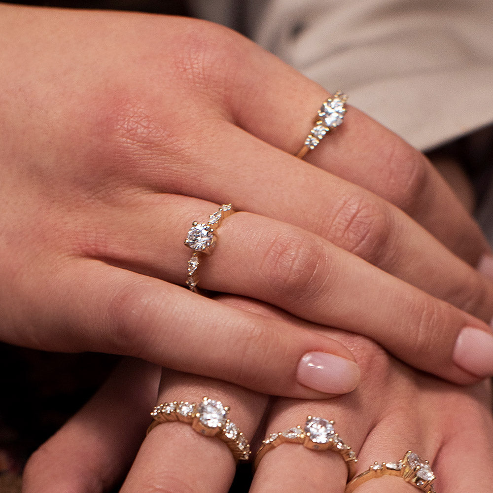 Engagement ring set with a 0.60 carat center round lab-grown diamond and marquise lab-grown diamonds