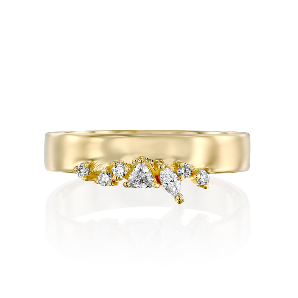 A wide gold ring with a special asymmetrical setting of diamonds in a variety of cuts.