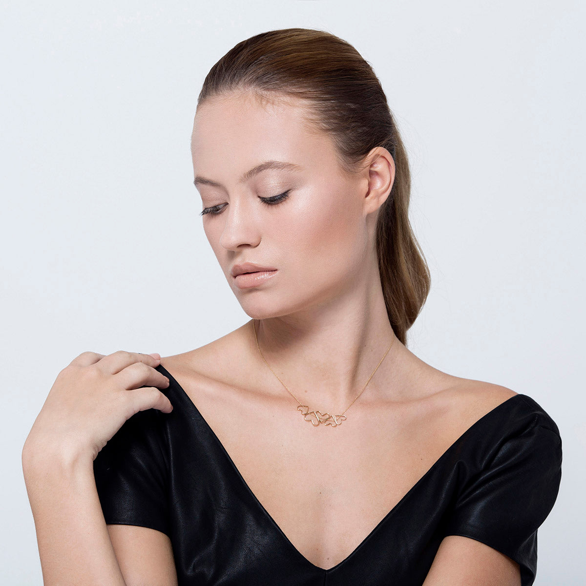 Gold heart necklace in varying sizes that move