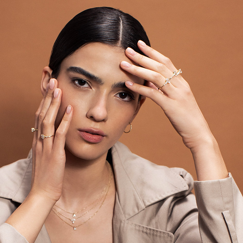 Engagement ring set with a 0.60 carat center round lab-grown diamond and marquise lab-grown diamonds