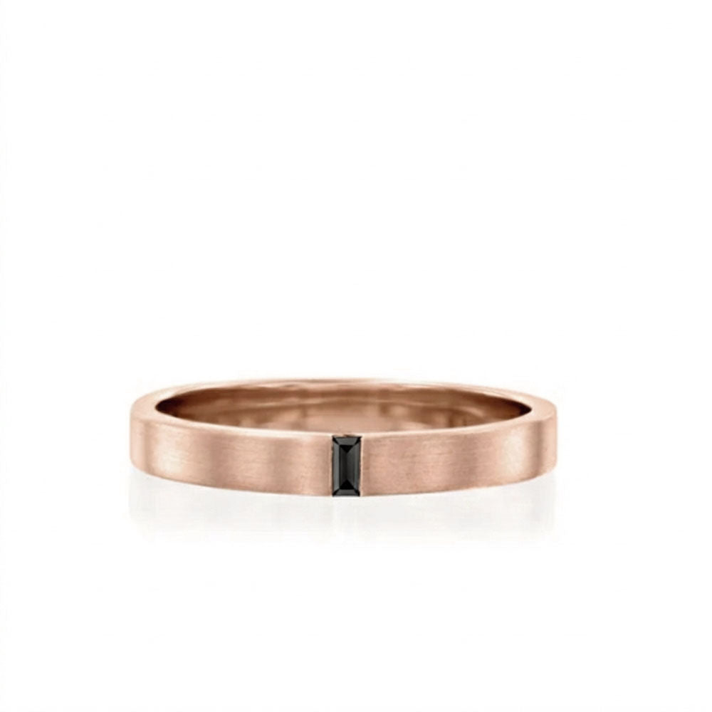 A flat gold ring for men and women set with a delicate black baguette diamond