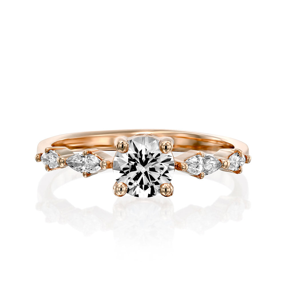 Engagement ring set with a 0.60 carat center round lab-grown diamond and marquise lab-grown diamonds