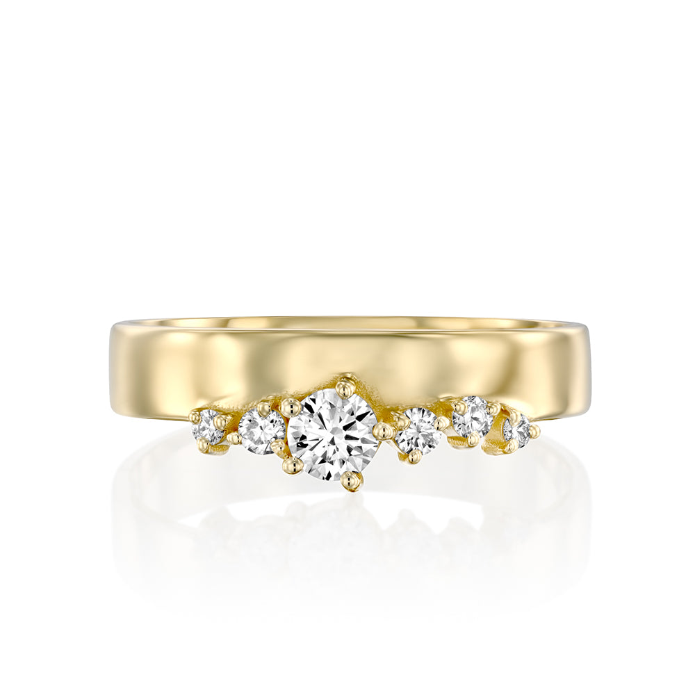 Wide gold ring with a special asymmetrical setting of diamonds