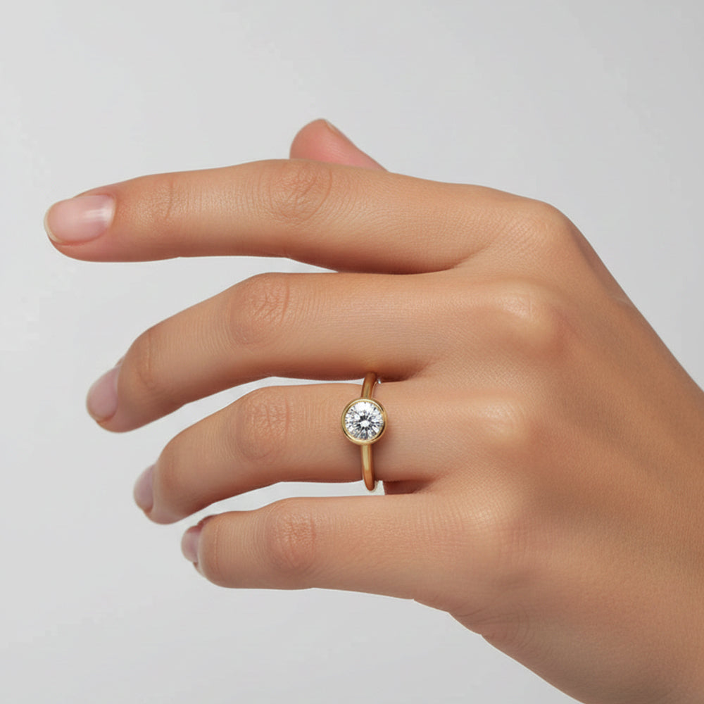 A solitaire ring set with a half-carat lab-grown diamond in a gold setting.