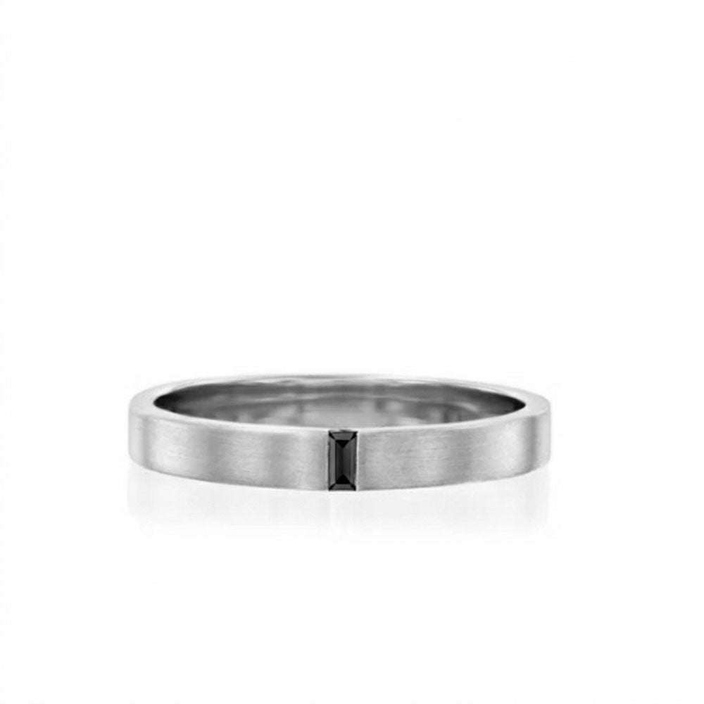 A flat gold ring for men and women set with a delicate black baguette diamond